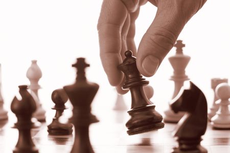Chess game black queen advances sepia tone