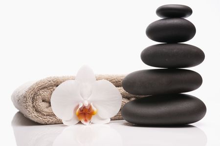 spa stones towel and orchid on white background の写真素材