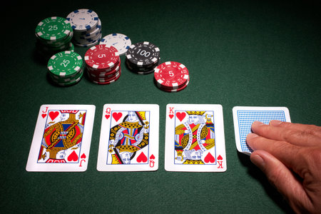 Poker hand royal flush win close up of cards with chips on green baize          のeditorial素材