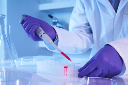 Scientist using pipette in laboratory selective focus の写真素材