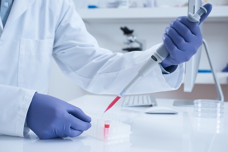 Scientist processing DNA sample in laboratory selective focus の写真素材