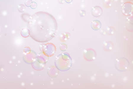 Soap bubbles on pastel pink background. Soap bubbles with rainbow colors.