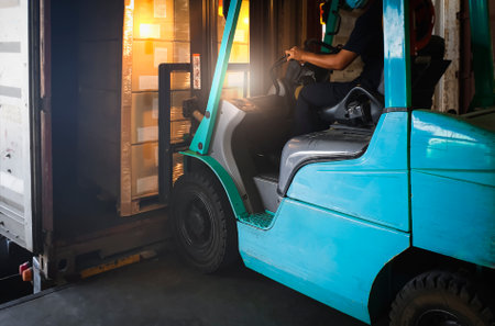 Forklift Tractor Loading Packaging Boxes into Container. Forklift Pallets Truck, Loader. Cargo Sending to Customers. Shipment Supplies Warehouse. Freight Truck Transport Logisticsの写真素材