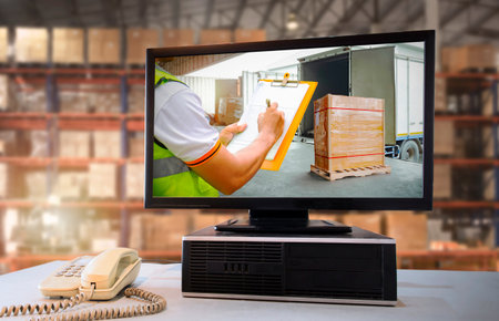 Computer Screen with Workers Controlling the Loading of Cargo into Shipping containers. Cargo...