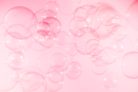 Beautiful Transparent Soap Bubbles Floating in The Air. Pink Textured Abstract Background. Celebration Festive Backdrop. Freshness Pink Soap Suds Bubbles Water.の写真素材