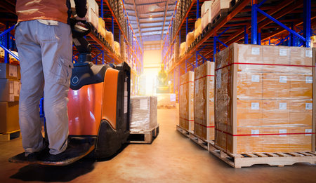 Workers Unloading Package Boxes on Pallets in Storage Warehouse. Forklift Pallet Jack Loader. Delivery Parcels Boxes Pallets. Supply Chain Shipment Goods. Distribution Suppliesの写真素材