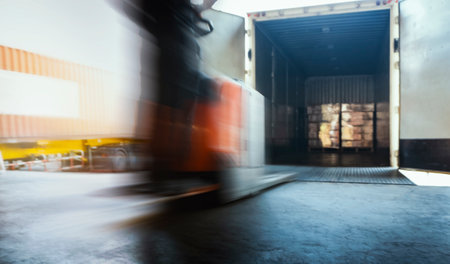 Motion Blurred of Workers Loading Package Boxes into Cargo Container. Shipment Boxes. Delivery to...