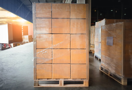 Package Boxes Stack on Wooden Pallets Loading into Container Trucks. Distribution Supplies Warehouse Shipping. Supply Chain, Shipment. Freight Truck Logistic, Cargo Transport.の写真素材