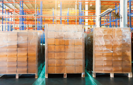 Package Boxes Wrapped Plastic on Pallets in Storage Warehouse. Storehouse Distribution Storage....
