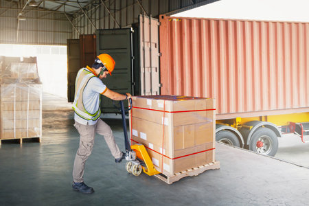 Warehouse Workers Loading a Package Pallets at Warehouse. Container Shipping. Supply Chain, Supplies Shipment, Freight Truck Logistic, Cargo Transport.の写真素材