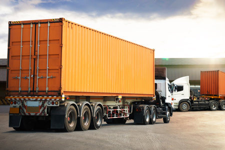 Semi Trailer Trucks on The Parking Lot at Warehouse. Truck Loading Goods at Warehouse. Container Shipping. Tractor Truck. Trucking. Lorry Diesel Trucks. Freight Truck Logisticsの写真素材