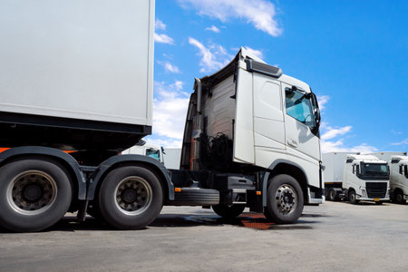 Semi Trailer Trucks on The Parking Lot. Container Shipping Tractor Truck. Trucking. Lorry Diesel Trucks. Freight Truck Logistics Cargo Transport.の写真素材