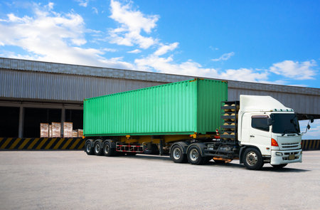 Semi Trailer Trucks on The Parking Lot at Warehouse. Truck Loading Goods at Warehouse. Container...