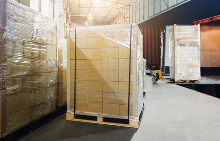 Bulk Pallets of Packaging Boxes Being Loaded onto a Container Trucks. Distribution Warehouse Container Transport, Supply chain, Parcel Delivery. Freight truck, Logistics, Transportの写真素材