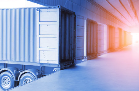 Container Trailer Trucks Parked Loading Goods at Warehouse Dock. Cargo Container Shipping. Freight Truck Logistics, Transportation.の写真素材