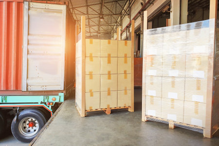 Package Boxes Wrapped Plastic Stacked on Pallets Loading into Container Trucks. Distribution...
