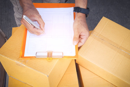Workers check invoices for shipping to customers. Business e- commerce. Delivery parcels boxes....