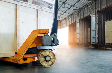 Hand Pallet Truck and Wooden Crates Pallets. Loading Container Trucks at Warehouse Dock. Distribution Warehouse Shipping, Supply Chain, Shipment. Freight Logistics Transportationの写真素材