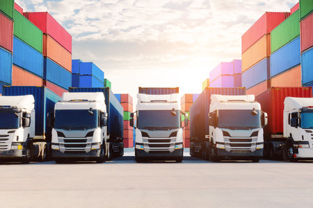 Semi trailer Trucks and Stacked Containers at Port. Handling of Logistics Transportation Industry....