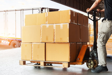 Workers Loading Package Boxes into The Truck. Forklift Pallet Jack. Package Boxes. Shipping Container. Distribution Warehouse, Supply Chain, Shipment, Freight Truck Logisticsの写真素材