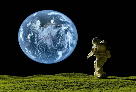 Astronaut on the grass against the skyの写真素材