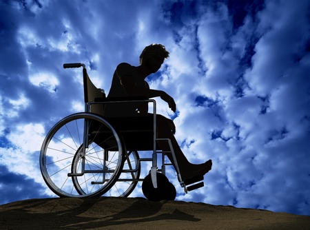 Silhouette of man on a wheelchairの写真素材