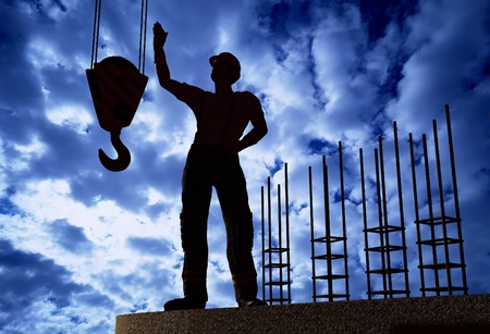 Silhouette of a worker on a background skyの写真素材