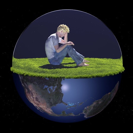 A young man in the green grass.の写真素材