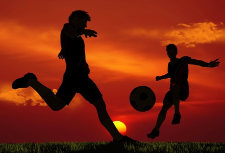 Silhouettes of soccer players.の写真素材