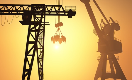 Silhouettes of construction cranes against the evening sky. .の写真素材