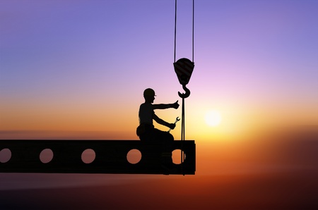 Silhouette of a worker on a background skyの写真素材