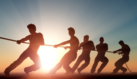 Group of people pulling the rope in the sunlight.の写真素材