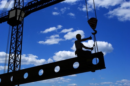Silhouette of a worker on a background skyの写真素材