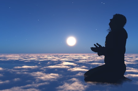 A silhouette of a priest on cloudsの写真素材