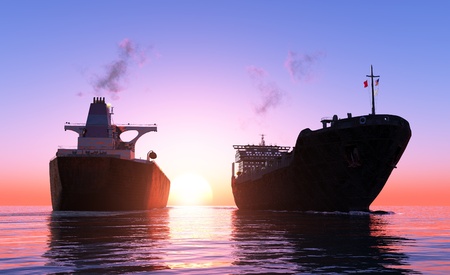 Two cargo ship at sunset.