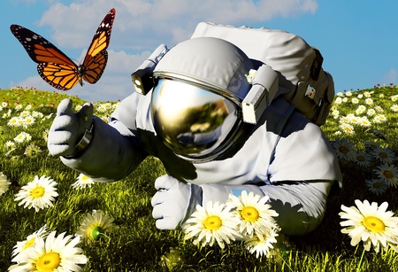 Astronaut and a butterfly on the grass.の写真素材