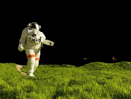 Astronaut on the grass against the skyの写真素材