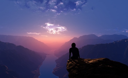 Silhouette of a man on a rock.の写真素材