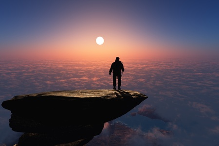 Silhouette of a man on a rock.
