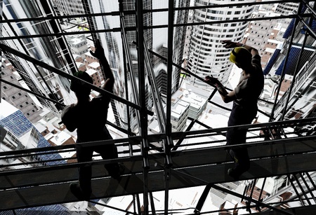 Silhouettes of workers against the background of the city.