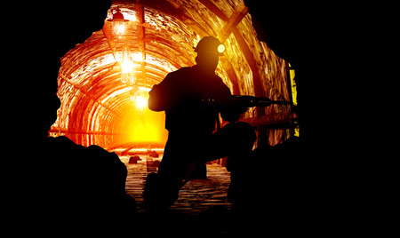 Silhouettes of worker in the mine.の写真素材
