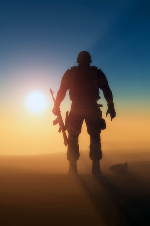Silhouette of a soldier against the sun.の写真素材
