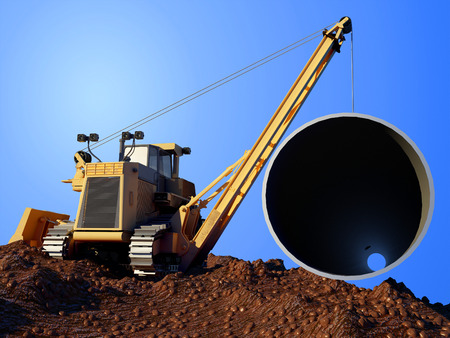 Construction machinery laying pipe in the ground.