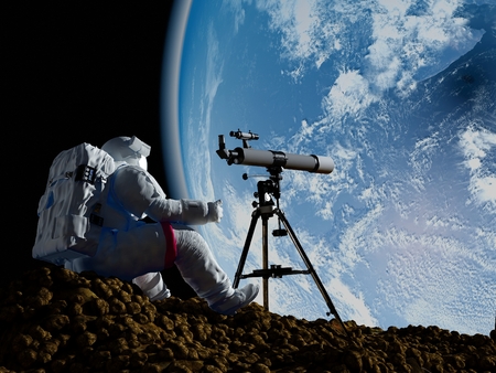 An astronaut looks through a telescope at Earth.の写真素材