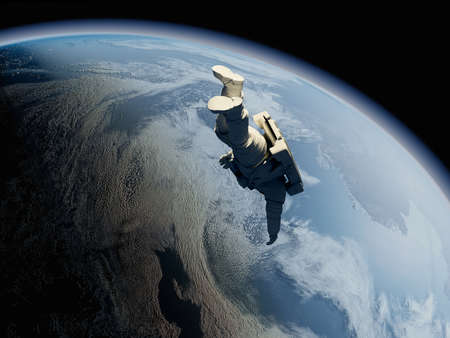 Astronaut flying over the planet. "Elemen ts of this image furnishedの写真素材