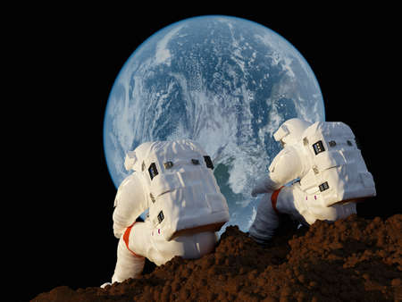 Two astronauts in space on the backdrop of the planet.の写真素材