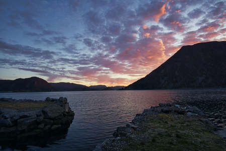 Sunset on the fjord of Selje Norway. very beautiful colors reflected in the clouds and the water. Fishing vacation in fantastic landscapeの写真素材