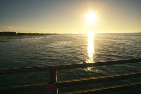 sunset on the beach of zingst on the baltic sea. with view of the sea and beautiful colors of the skyの写真素材