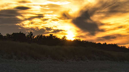 sunset on the beach of the baltic sea in zingst. warm light atmosphere. resortの写真素材