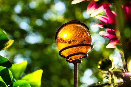 yellow glass ball in the sunlight on the balcony. sometimes the beautiful things are so nearの写真素材
